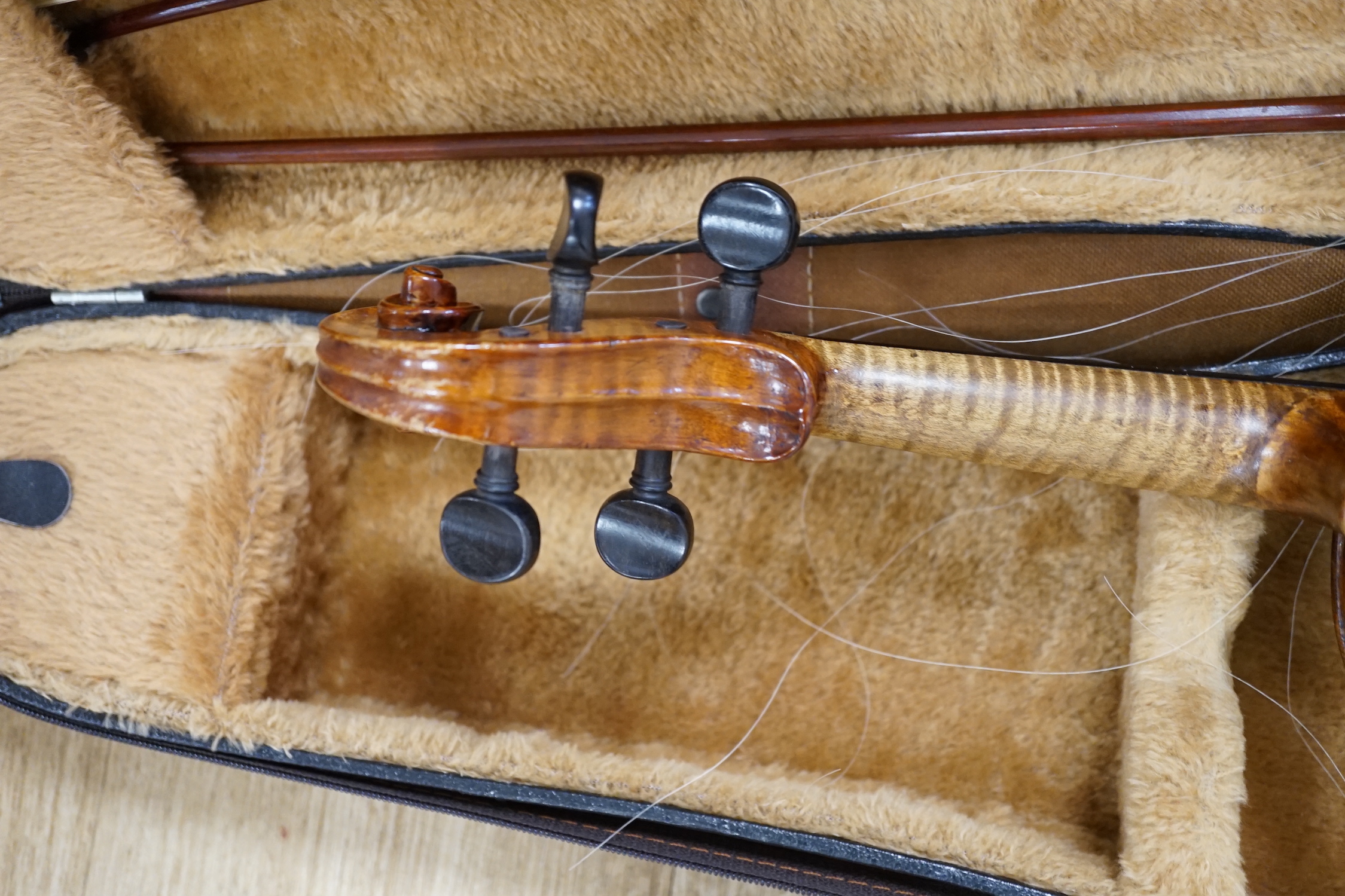 A cased 19th century German violin with paper label for August Hensel, length of body, 36cm, with two bows, CITES submission references, FBHZDSA1 and ZCXXMHV4